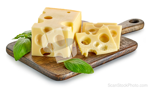 Image of pieces of cheese on wooden cutting board