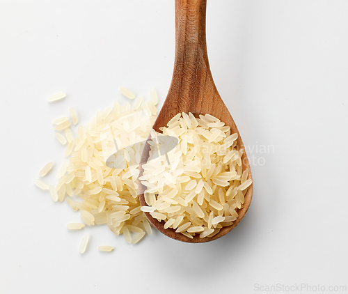 Image of raw rice in wooden spoon