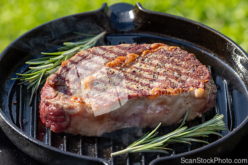 Image of beef steak on grilling pan