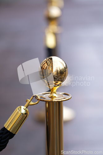 Image of Golden pole of a rope fence