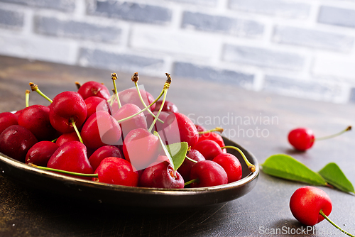 Image of Freshly harvested cherries in a bowl. Fresh sweet organic cherries