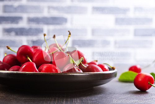 Image of Freshly harvested cherries in a bowl. Fresh sweet organic cherries