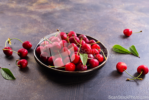 Image of Freshly harvested cherries in a bowl. Fresh sweet organic cherries