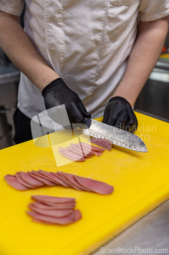 Image of Professional chef slicing tuna