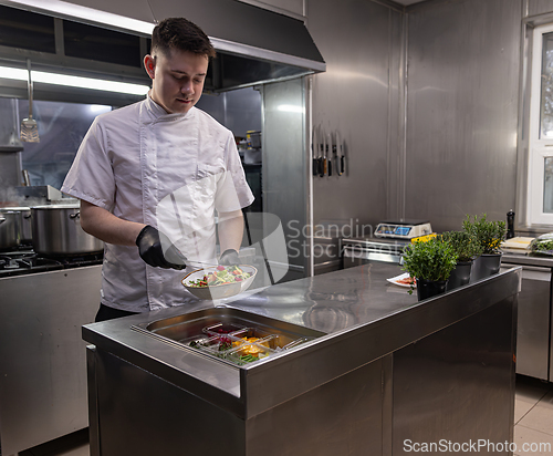 Image of Young chef using tongs