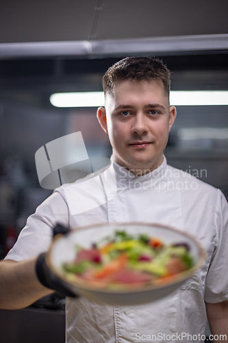 Image of Chef holding gourmet salad