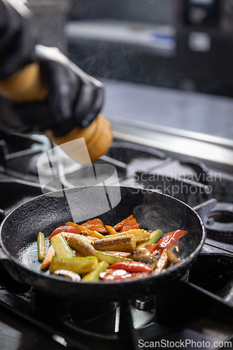 Image of Chef grinding salt into a pan
