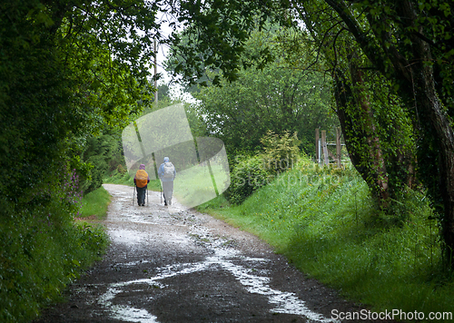 Image of Two backpackers on a dirt road