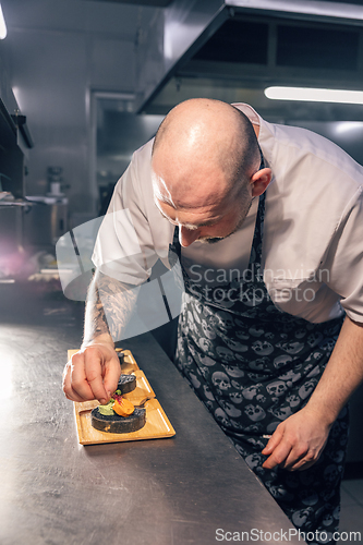 Image of Chef garnishing gourmet dish