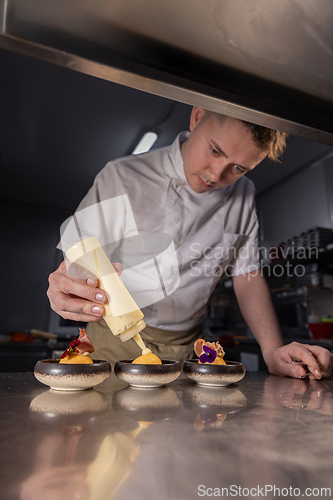 Image of Chef garnishing small dishes