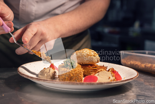 Image of Professional chef carefully placing finishing touches