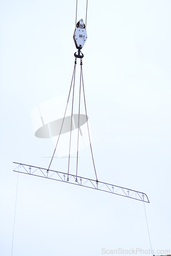 Image of Crane lifting a metal structure