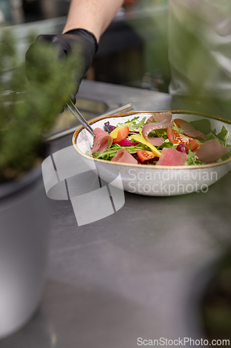 Image of Chef holding gourmet salad