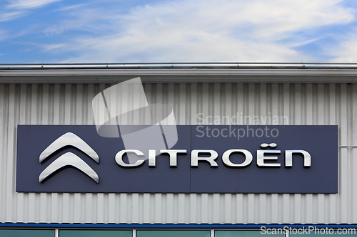 Image of Citroen Logo With Blue Sky and Clouds