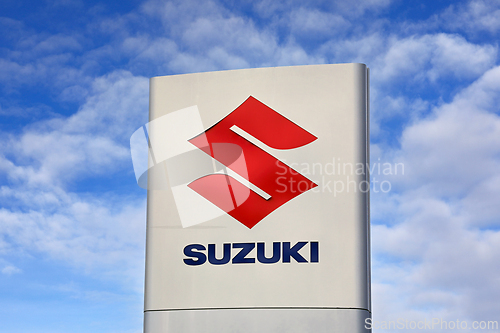 Image of Suzuki Logo Against Blue Sky and Clouds 2
