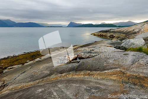 Image of Scenic coastal view with rocky shoreline and calm waters in a mi
