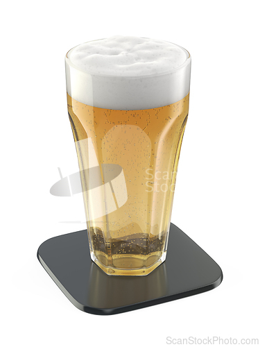 Image of Glass of lager beer on shiny black coaster