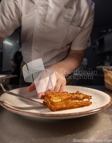 Image of Professional chef plating a delicious potato gratin