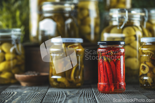 Image of Jars of pickled red chili peppers