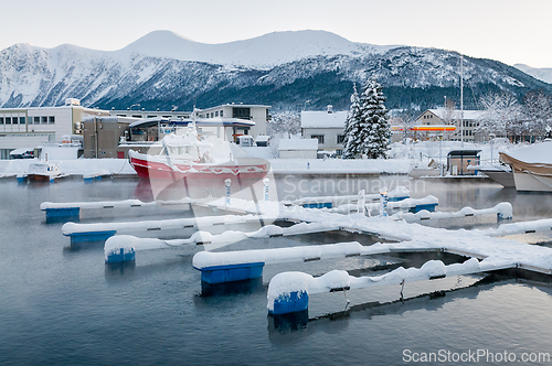 Image of Winter landscape with snow-covered marina and boats in a serene 