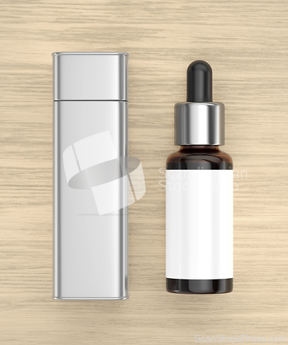 Image of Brown glass dropper bottle and silver box