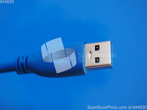 Image of USB plug over blue