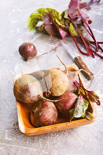 Image of Fresh organic beets just picked from the garden shot on a stone table.