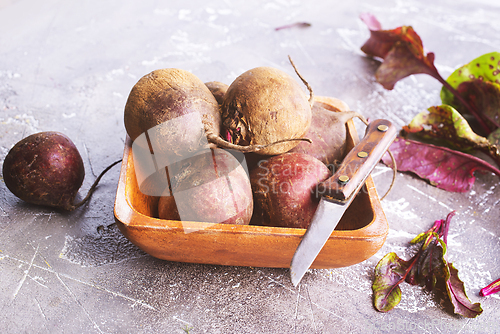Image of Fresh organic beets just picked from the garden shot on a stone table.