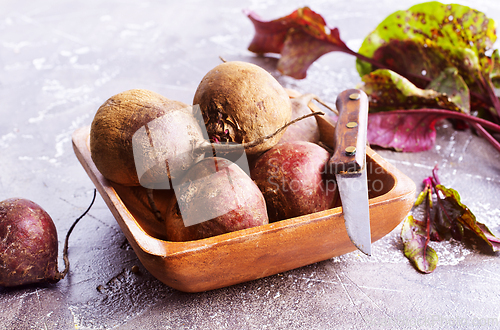 Image of Fresh organic beets just picked from the garden shot on a stone table.