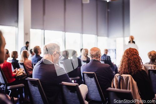 Image of Woman giving presentation on business conference event.