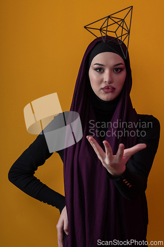 Image of Elegant Muslim woman in a hijab with a geometric structure in a conceptual portrait.