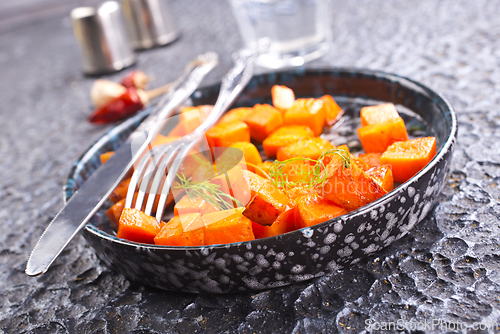 Image of Delicious homemade roasted sweet potato with herbs, salt and pepper