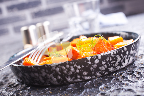 Image of Delicious homemade roasted sweet potato with herbs, salt and pepper
