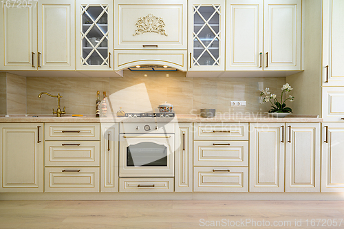 Image of Beige furniture at kitchen in provence style, front view