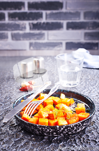 Image of Delicious homemade roasted sweet potato with herbs, salt and pepper