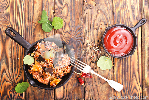 Image of fried rice with vegetables, rice with eggplant and onion