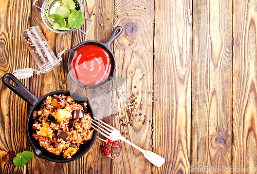 Image of fried rice with vegetables, rice with eggplant and onion