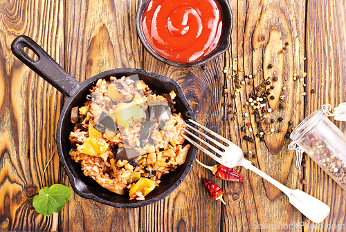 Image of fried rice with vegetables, rice with eggplant and onion