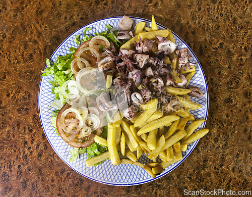 Image of Baby octopuses and french fries on a plate