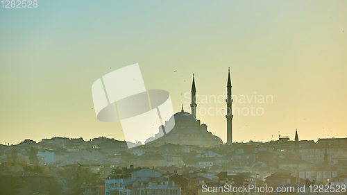 Image of Silhouette of a Mosque Fatih in a fog and sunlight reflections. Vintage style.