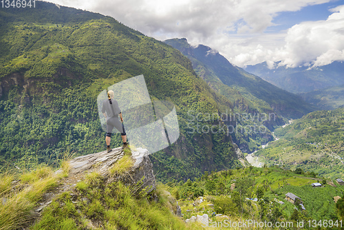 Image of Man standing on hill top in Himalayas