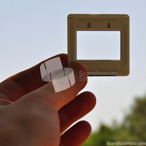 Image of hand holding photographic slide