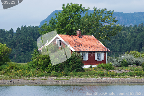 Image of Small, red house by the sea