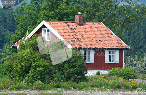 Image of Small, red house among trees