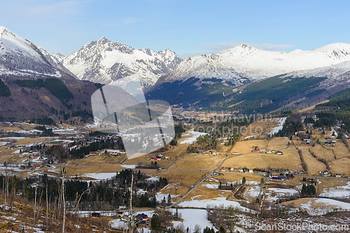 Image of Snow-capped mountains and tranquil valleys in a stunning winter 