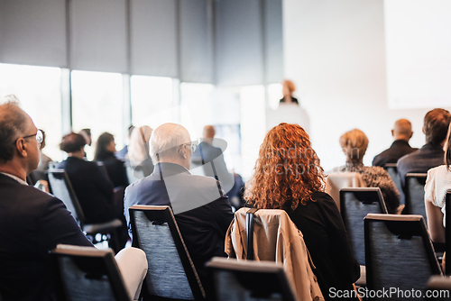 Image of Woman giving presentation on business conference event.