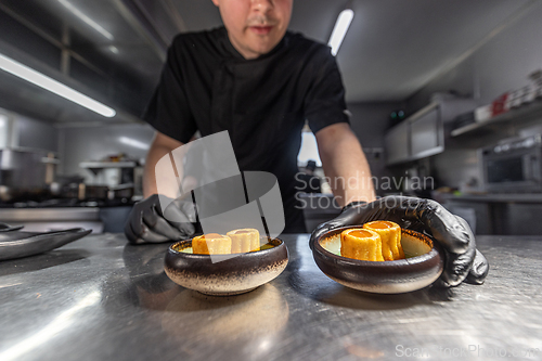 Image of Chef finishing gourmet appetizers