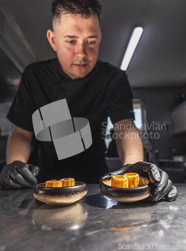 Image of Professional chef plating elegant appetizers