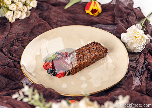 Image of Chocolate cake slice with berry coulis