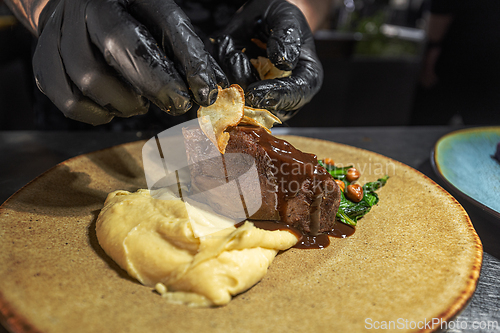 Image of Professional chef preparing a delicious plated dish